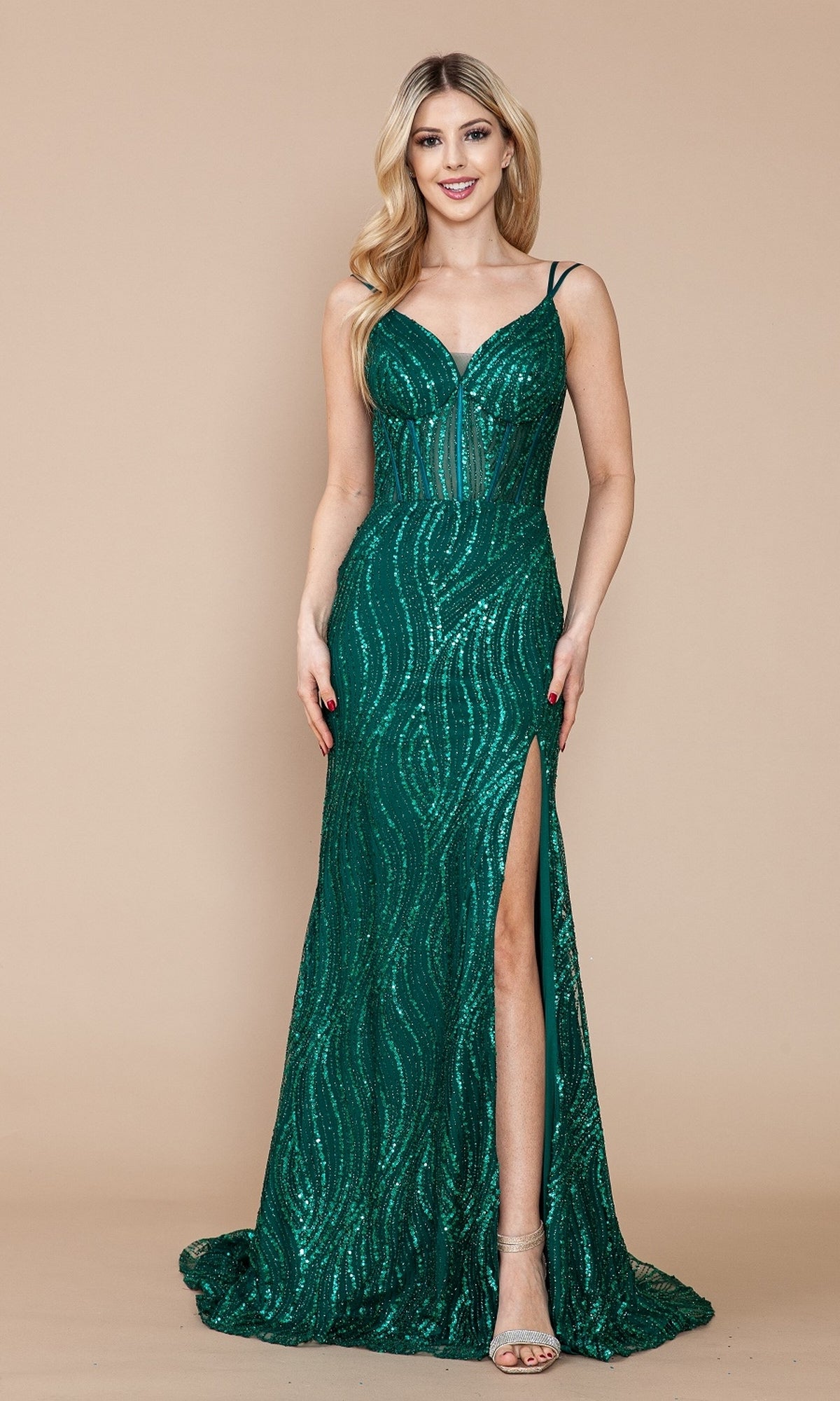 A woman wearing the Sequin-Print Sheer-Waist Long Prom Dress 9400, a fitted green gown with a thigh-high slit, stands against a plain beige background.